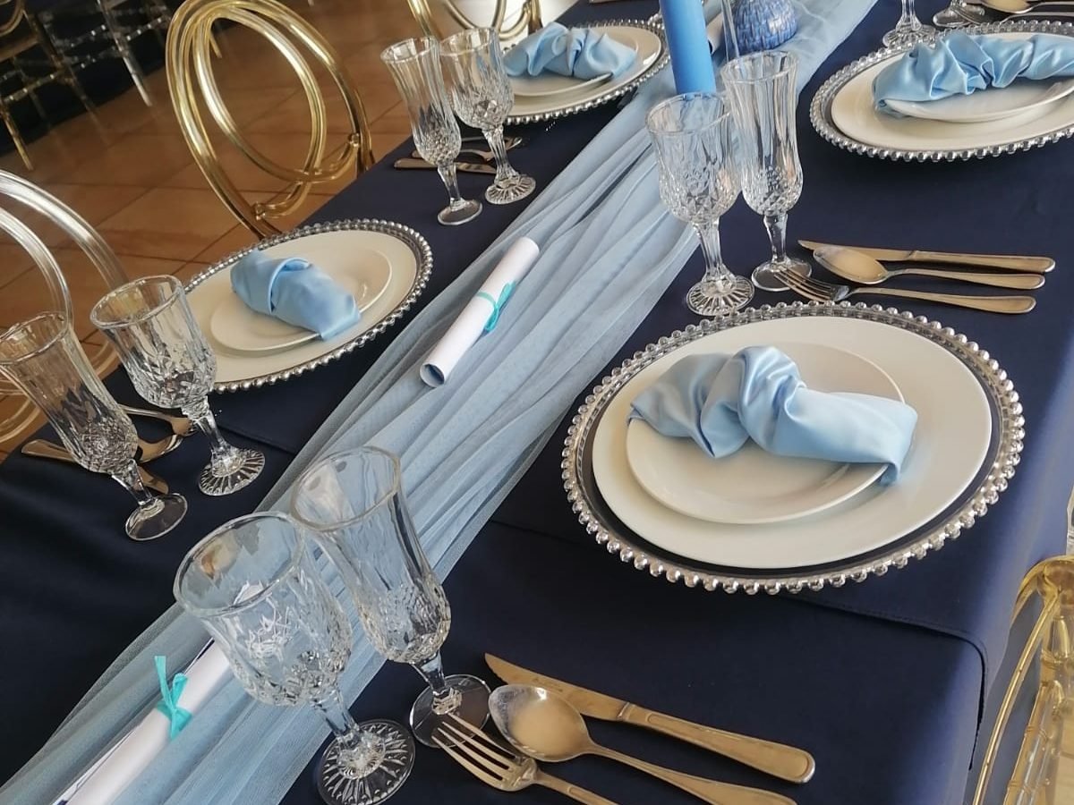 Close-up of a navy and pale blue table setting for a celebration